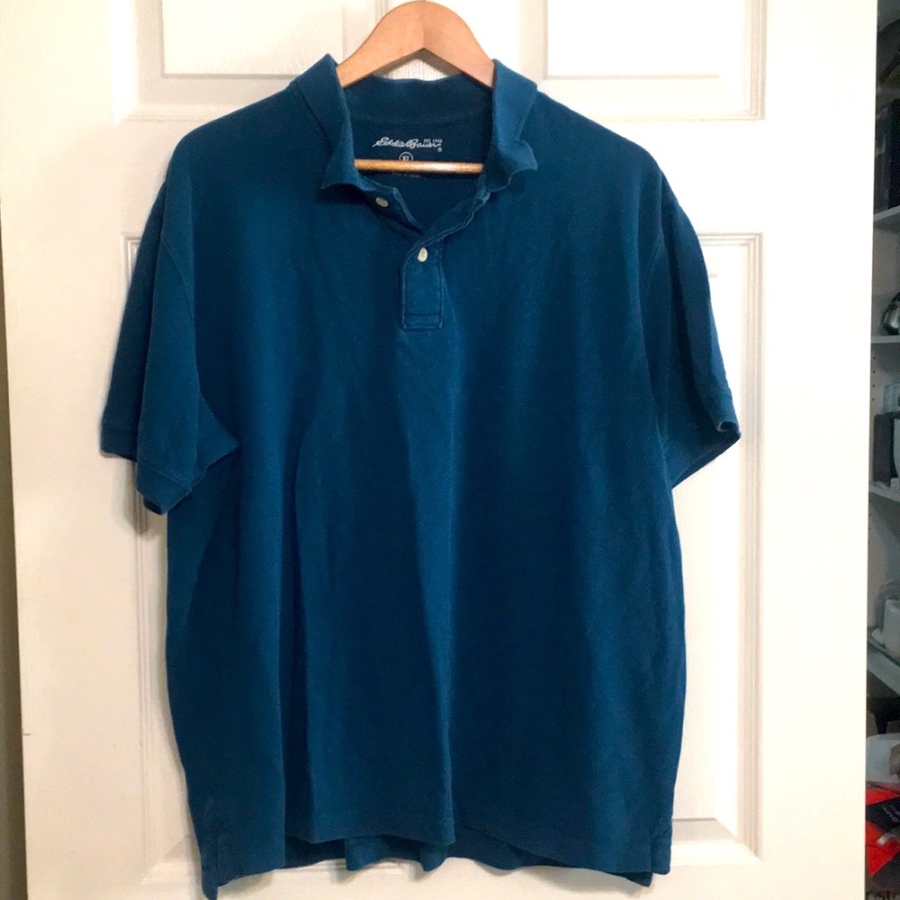 Dark teal-blue polo shirt.